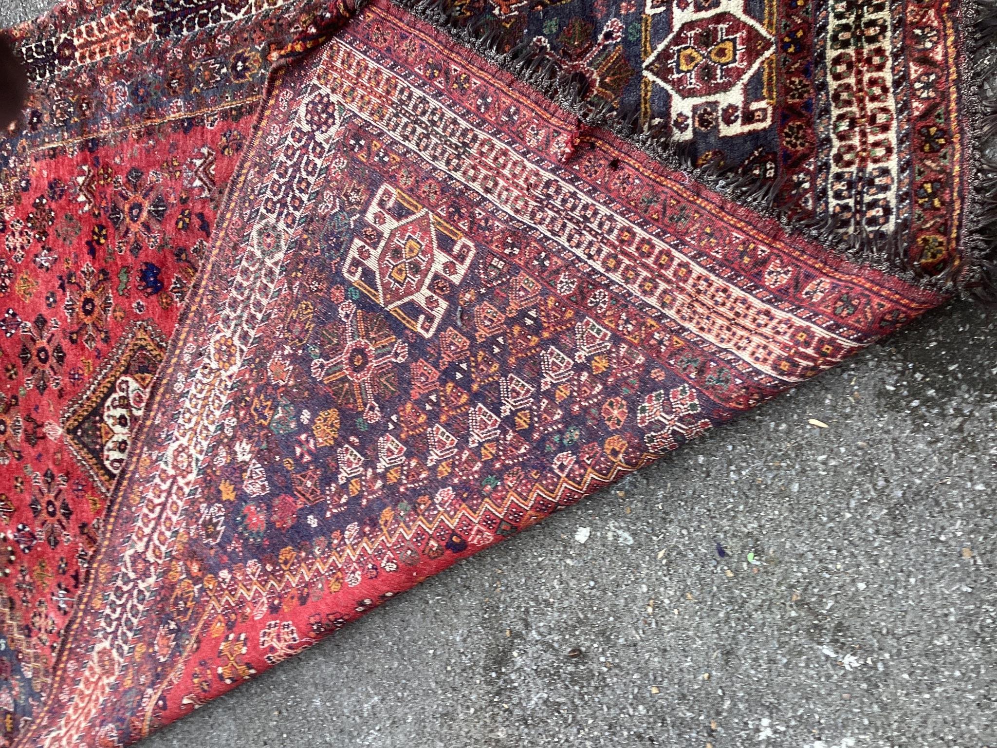 A Hamadan red ground carpet, 290 x 182cm